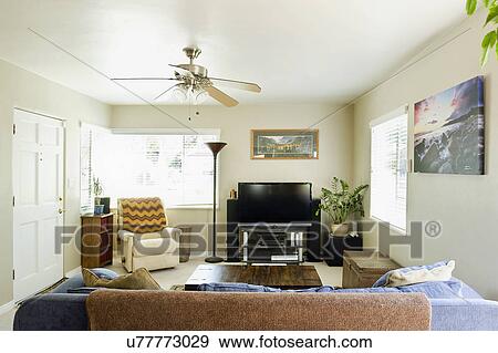 Armchair and entertainment center in living room View Large Photo Image Stock Photo - Armchair and entertainment center in living room. Fotosearch