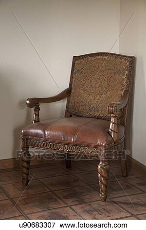 Stock Photo - Armchair with leather seat in corner; Porterville; California; USA. Fotosearch