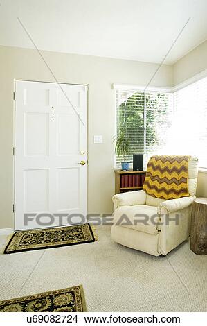 Picture - Armchair with throw blanket in a living room, San Diego, California, United States of America. Fotosearch