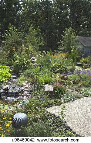 Stock Image - Back yard garden with flowing water. Fotosearch