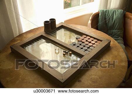 Stock Image - Backgammon game on table near window; Carpinteria; California; USA. Fotosearch