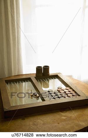 Stock Photo - Backgammon game on table near window; Carpinteria; California; USA. Fotosearch