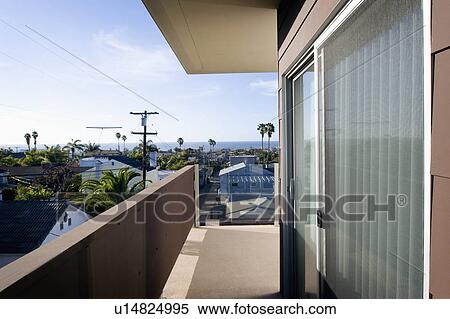 Stock Photography - Balcony along contemporary home with ocean view. Fotosearch
