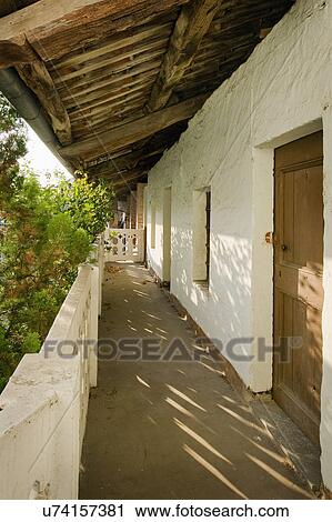 Stock Image - Balcony of an old residential structure in Albiano d'Ivrea, Italy. Fotosearch