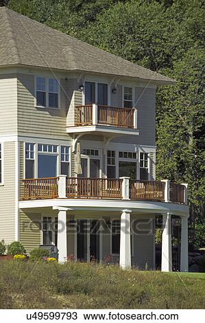 Stock Image - Balcony towards yard of a single family home. Fotosearch