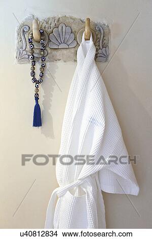 Bathrobe and beads hanging on wall hook, Mykonos, Greece View Large Photo Image Picture - Bathrobe and beads hanging on wall hook, Mykonos, Greece. Fotosearch
