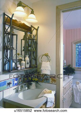 Stock Image - BATHROOM - Country, sink with hand painted tile backsplash. Twig shelf with mirror.. Fotosearch