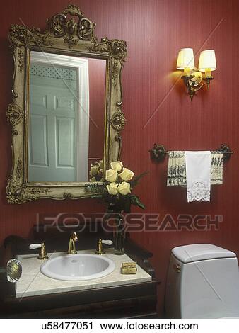 BATHROOMS: Small powder room, warm red raised-lined wallpaper, antique walnut vanity, ornate mirror and towel rack are flea market finds. View Large Photo Image Stock Image - BATHROOMS: Small powder room, warm red raised-lined wallpaper, antique walnut vanity, ornate mirror and towel rack are flea market finds.. Fotosearch