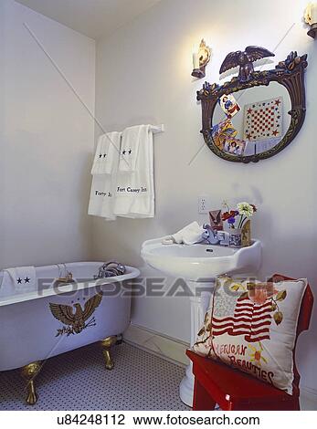 BATHROOMS: Vintage claw leg tub, mirror, decal on tub and flag pillow have patriotic theme. View Large Photo Image Stock Image - BATHROOMS: Vintage claw leg tub, mirror, decal on tub and flag pillow have patriotic theme. . Fotosearch