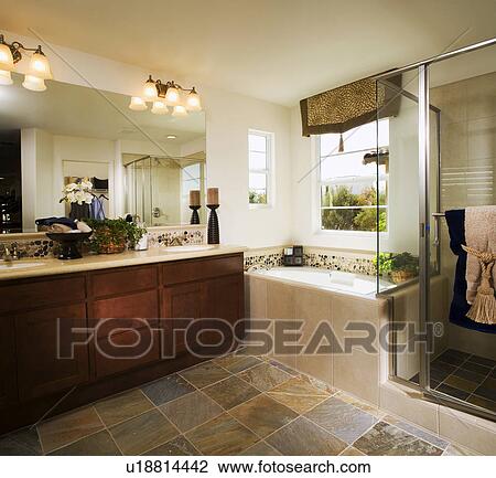 Stock Image - Bathtub in corner of master bath. Fotosearch