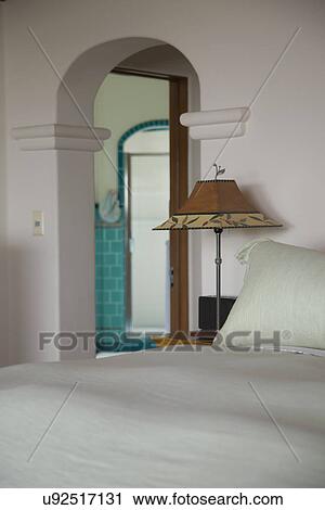Bed side lamp and arched doorway in bedroom; Carpinteria; California; USA View Large Photo Image Stock Image - Bed side lamp and arched doorway in bedroom; Carpinteria; California; USA. Fotosearch
