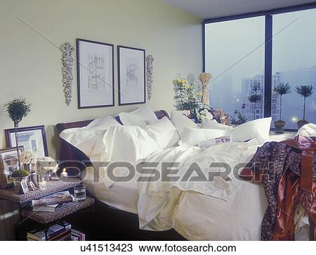 Bedrooms High Rise Contemporary Light Yellow Walls And Bed Clothes Topiary Architectural Drawings Over Bed Wicker Stacking Table Rose