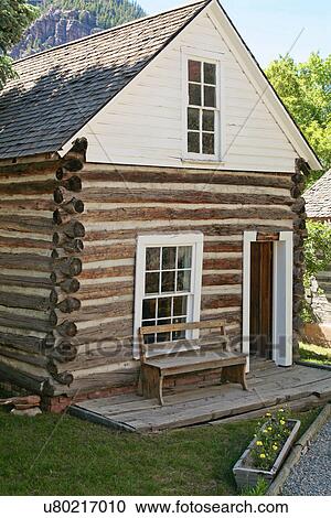 Stock Image - Bench outside log cabin, USA, Colorado, Ouray. Fotosearch