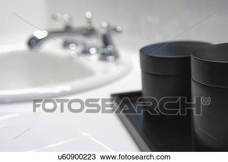 Stock Image - Black cylindrical boxes near bathroom sink; Aliso Viejo; California; USA. Fotosearch