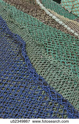Stock Photo - Blue and green commercial fishing nets. Fotosearch