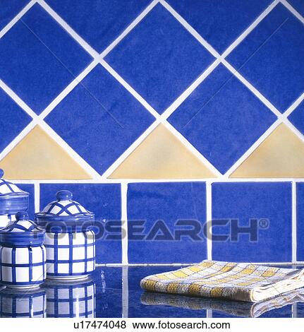 Blue and yellow ceramic tiled wall with canister set and dish towel on counter. View Large Photo Image Stock Photo - Blue and yellow ceramic tiled wall with canister set and dish towel on counter.. Fotosearch