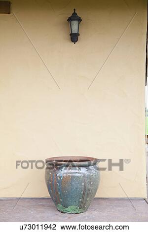 Stock Image - Blue ceramic pot outside home; Porterville; California; USA. Fotosearch