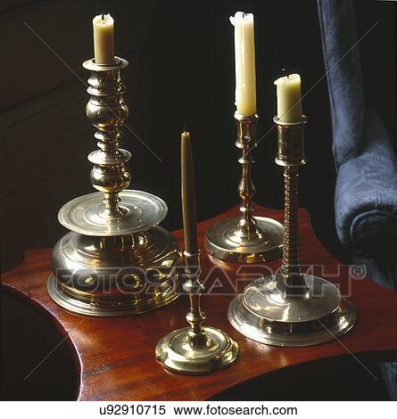 Stock Photography - Brass candlesticks in 18th century house on small side table. Fotosearch