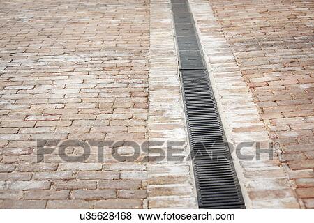 Stock Photo - Brick driveway with drainage grate; Irvine; California; USA. Fotosearch