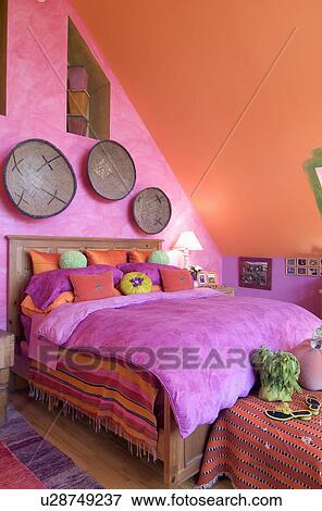Bright pink and orange bedroom; Tannersville; New York; USA View Large Photo Image Stock Photo - Bright pink and orange bedroom; Tannersville; New York; USA. Fotosearch