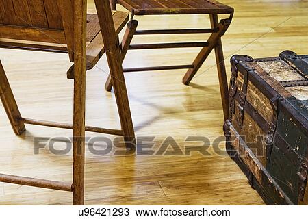 Brown wooden folding chairs and old storage trunk View Large Photo Image Stock Image - Brown wooden folding chairs and old storage trunk. Fotosearch