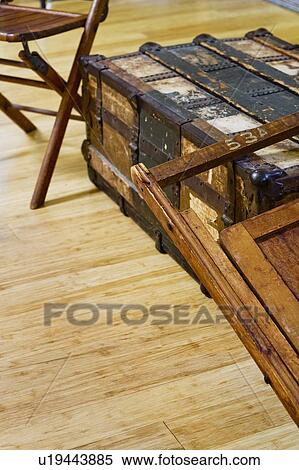 Stock Photography - Brown wooden folding chairs and old storage trunk. Fotosearch