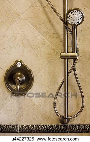 Stock Photography - Brushed aluminum shower faucet and detachable showerhead; Aliso Viejo; California; USA. Fotosearch