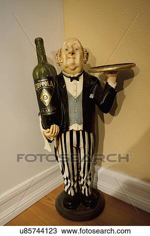 Stock Image - Butler statue in corner; Seal Beach; California; USA. Fotosearch