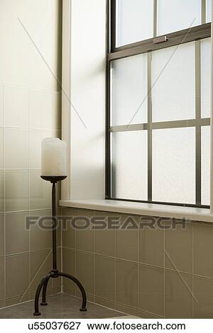 Stock Photo - Candle on stand along window; Burbank; California; USA. Fotosearch