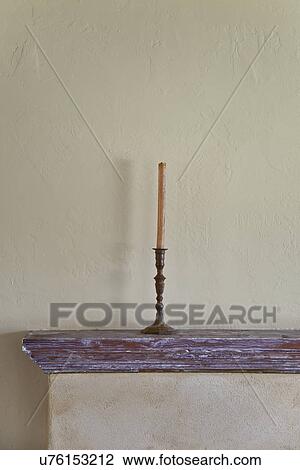 Stock Image - Candlestick on mantle. Fotosearch