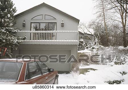 Car in front of garage of a traditional house View Large Photo Image Picture - Car in front of garage of a traditional house. Fotosearch