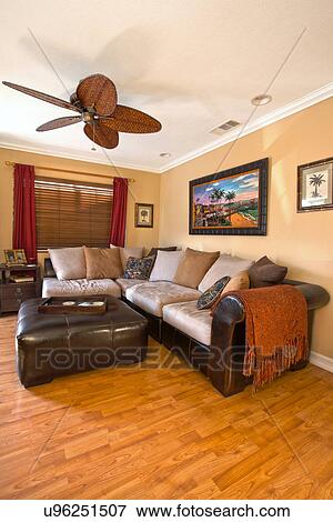 Stock Photo - Cat on wicker love seat; Seal Beach; California; USA. Fotosearch