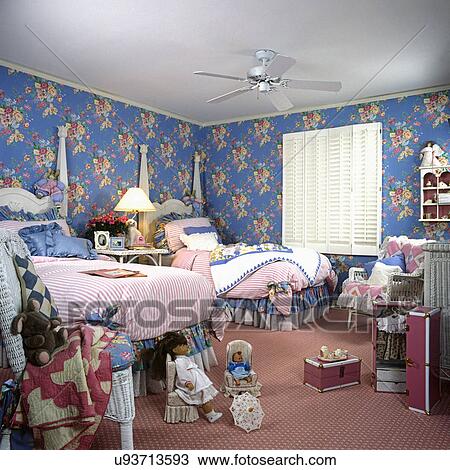 CHILDREN'S BEDROOM: Girl's twin two poster beds, blue and pink floral walls. Pink rug. White wood shutters at window. Dolls. View Large Photo Image Stock Image - CHILDREN'S BEDROOM: Girl's twin two poster beds, blue and pink floral walls. Pink rug. White wood shutters at window. Dolls.. Fotosearch