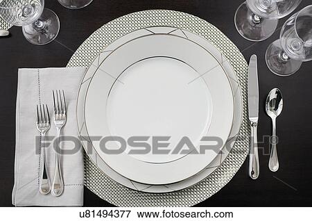Stock Photo - Close-up of an elegant place setting on dining table. Fotosearch