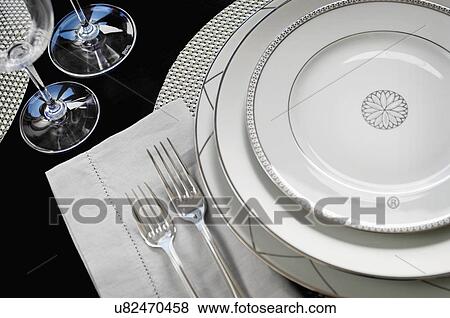 Stock Photo - Close-up of an elegant place setting on dining table. Fotosearch