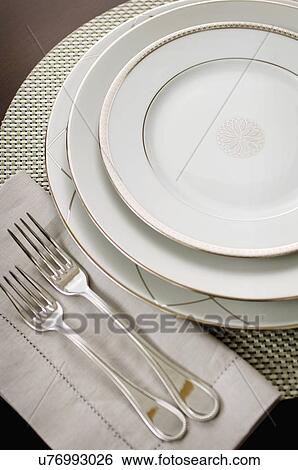 Stock Photograph - Close-up of an elegant place setting on dining table. Fotosearch