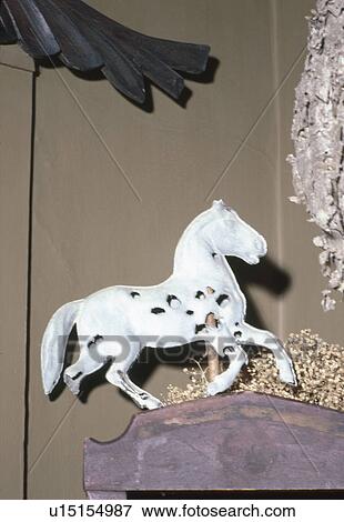 Stock Photo - Close-up of broken horse statue against wall. Fotosearch