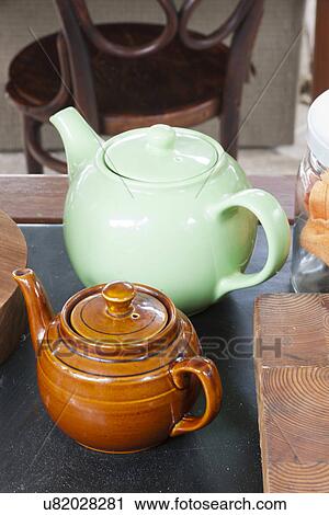 Stock Image - Close-up of ceramic teapots on table. Fotosearch