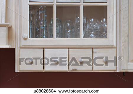 Picture - Close-up of drinking glasses wooden storage compartment. Fotosearch