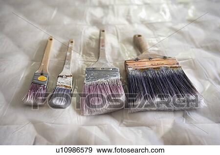 Stock Photo - Close-up of paint brush on mattress. Fotosearch