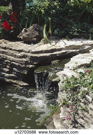 Stock Photo - Close-up of small garden waterfall. Fotosearch