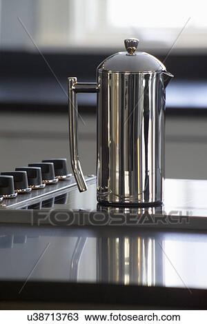 Stock Image - Close-up of stainless steel kettle on stove. Fotosearch