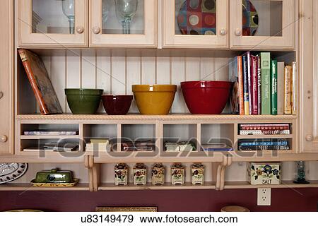 Close-up of storage compartment with books and bowls View Large Photo Image Stock Photo - Close-up of storage compartment with books and bowls. Fotosearch