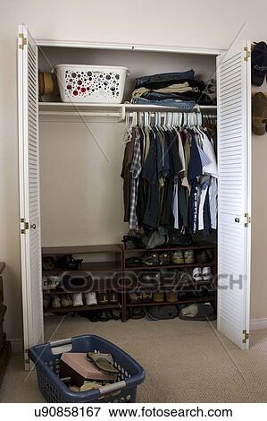Clothes and shoes in closet, San Diego, California, United States of America View Large Photo Image Stock Photo - Clothes and shoes in closet, San Diego, California, United States of America. Fotosearch