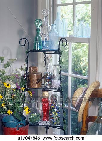 COLLECTIBLES - GLASS: Collection of old bottles displayed on rack with garden equipment. Marbles, vials and candy add interest and color. View Large Photo Image Stock Photography - COLLECTIBLES - GLASS: Collection of old bottles displayed on rack with garden equipment. Marbles, vials and candy add interest and color.. Fotosearch