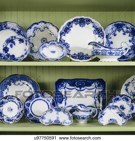 COLLECTION DISPLAY: Flow blue plate collection on green shelves in a wainscot cupboard, stencils are faint on the wainscot View Large Photo Image Stock Image - COLLECTION DISPLAY: Flow blue plate collection on green shelves in a wainscot cupboard, stencils are faint on the wainscot. Fotosearch