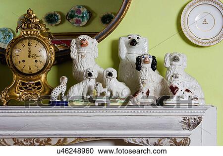 COLLECTION DISPLAY: mantel display, Swedish mantel clock, porcelain English Chelsea dog figurines, chartreuse wall, View Large Photo Image Stock Image - COLLECTION DISPLAY: mantel display, Swedish mantel clock, porcelain English Chelsea dog figurines, chartreuse wall,. Fotosearch