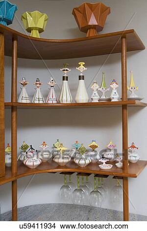 Picture - COLLECTION DISPLAY: Mid century modern open shelving in kitchen, Red Wing pottery vases on top, Japanese Holt-Howard novelty kitchen condiment containers from 1958. Fotosearch