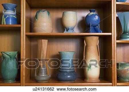 Stock Image - COLLECTION DISPLAY: shelf display of Roseville's Futura art pottery, made only in the year 1928, highly sought. Fotosearch