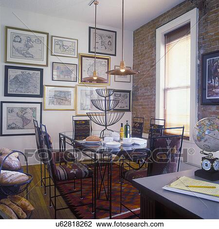 COLLECTION DISPLAYS: Desk, globe. Map collection on wall, exposed brick wall, kilim rugs cute into chair cushions, hanging lights, View Large Photo Image Stock Image - COLLECTION DISPLAYS: Desk, globe. Map collection on wall, exposed brick wall, kilim rugs cute into chair cushions, hanging lights,. Fotosearch